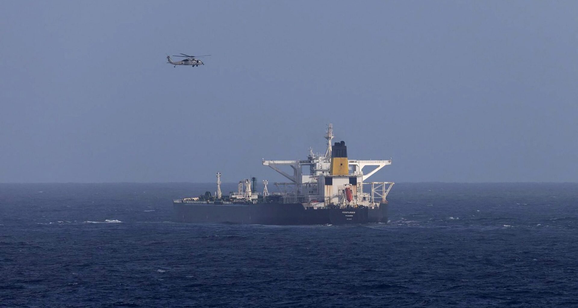 A U.S. military helicopter flies over the Panama-flagged Centuries, which was intercepted by the U.S. Coast Guard, days after U.S. President Donald Trump announced a "blockade" of all sanctioned oil tankers