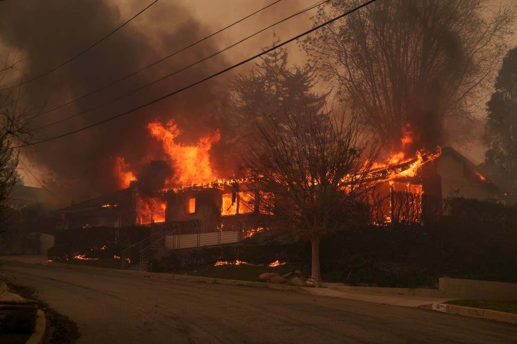 Flames from the Palisades Fire burning a home in the Pacific Palisades neighborhood of Los Angeles.