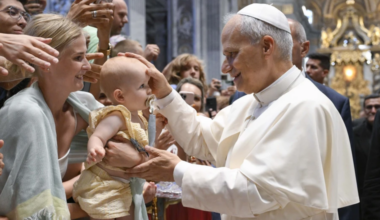Pope Leo XIV blesses a baby during his Wednesday general audience in St. Peter’s Basilica on Aug. 13, 2025, at the Vatican.