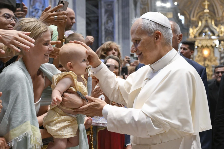Pope Leo XIV blesses a baby during his Wednesday general audience in St. Peter’s Basilica on Aug. 13, 2025, at the Vatican.