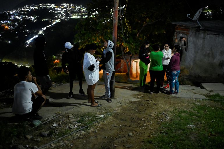 Residents stand in front of their homes in the Gramoven neighborhood, as U.S. President Donald Trump said on Saturday the U.S. has struck Venezuela and captured its President Nicolas Maduro, in Caracas, Venezuela January 3, 2026. REUTERS/Maxwell Briceno