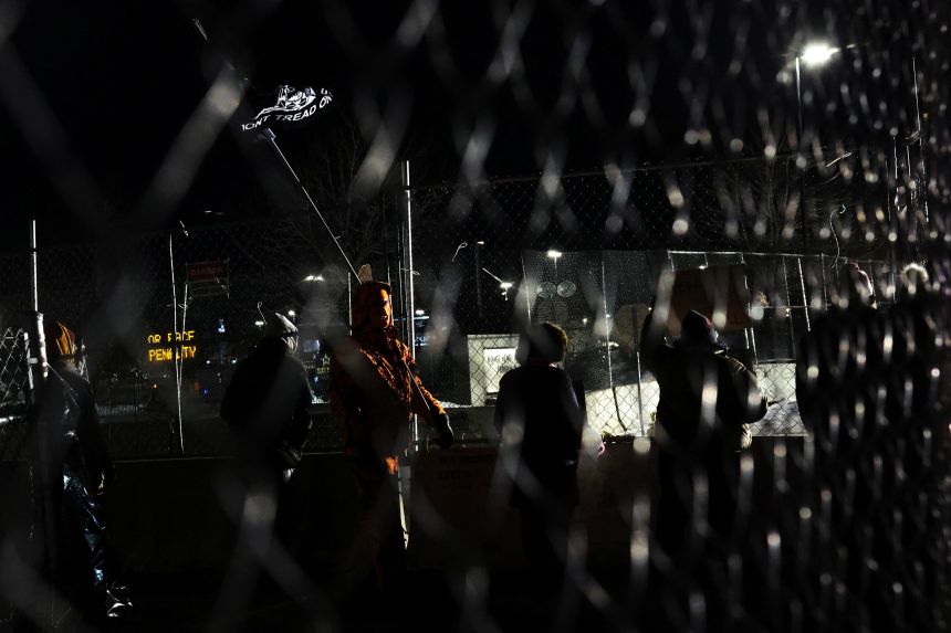 Demonstrators shout against the presence of federal immigration agents outside the Bishop Henry Whipple Federal Building in Minneapolis, Minnesota, on January 28, 2026.