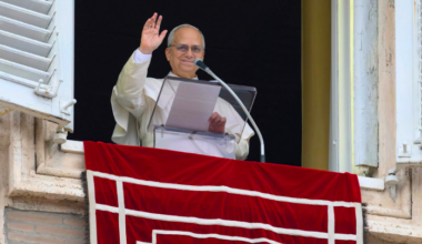 Pope Leo XIV waves to crowds in St. Peter's Square after praying the Angelus on Jan. 18, 2026.