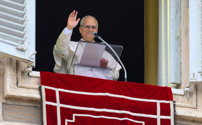 Pope Leo XIV waves to crowds in St. Peter's Square after praying the Angelus on Jan. 18, 2026.