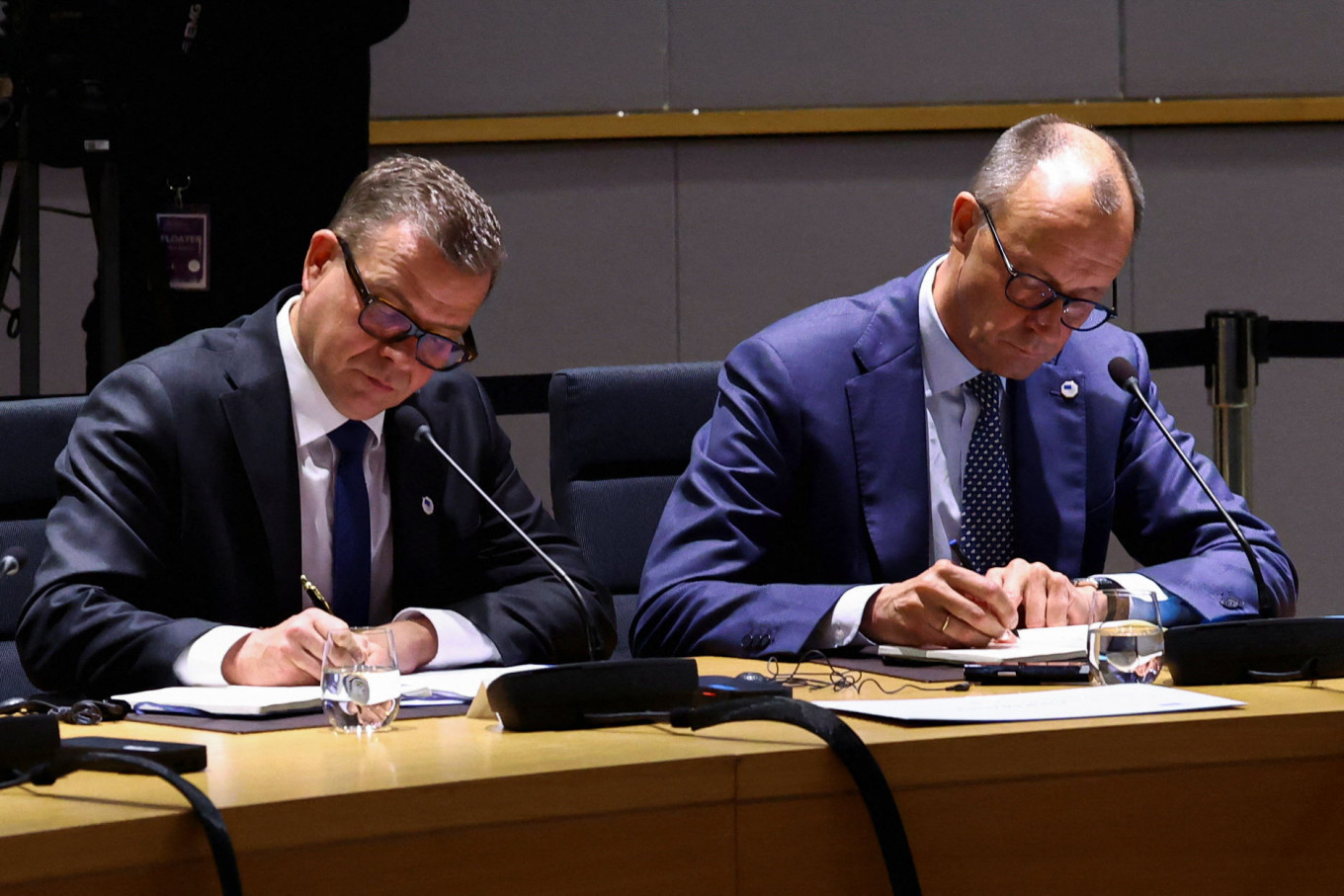 Finnish Prime Minister Petteri Orpo and German Chancellor Friedrich Merz sit at the roundtable on the day of a special summit of European Union leaders to discuss transatlantic relations following US President Donald Trump's threats to impose new tariffs on goods from a list of EU countries over his demand to acquire Greenland, in Brussels, on Jan. 22, 2026.