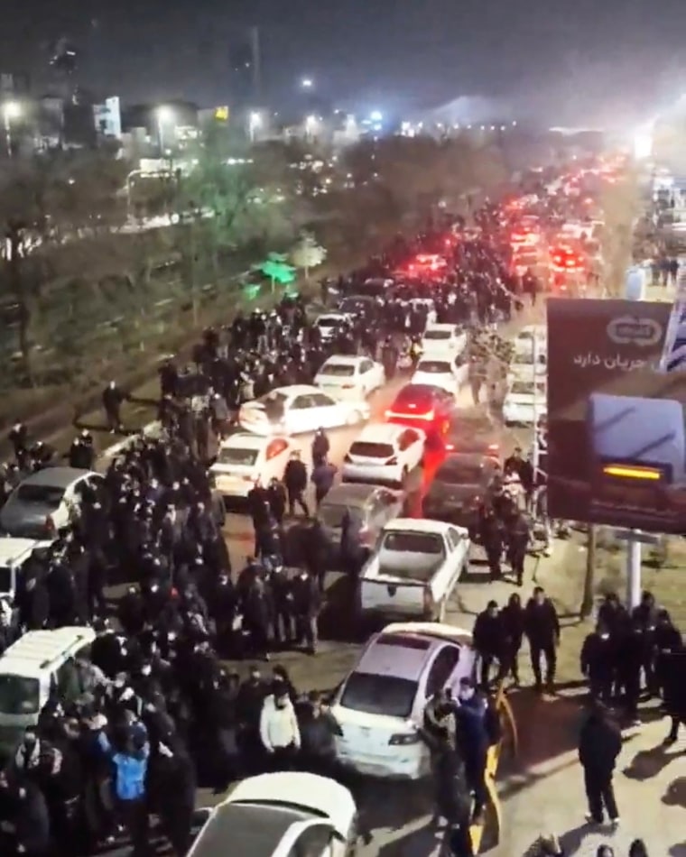People gather on the streets during a protest in Mashhad