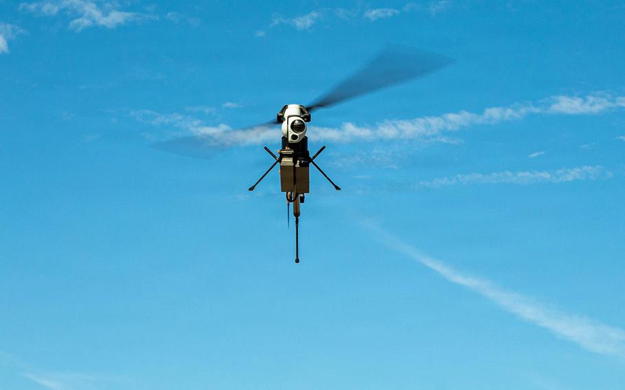 A drone flies overhead.