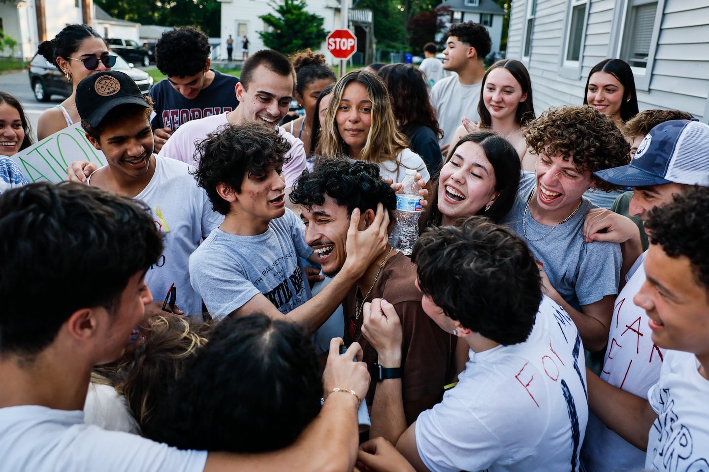 Marcelo Gomes da Silva (center) was embraced by friends outside his Milford home on June 5, after his release from ICE detention.