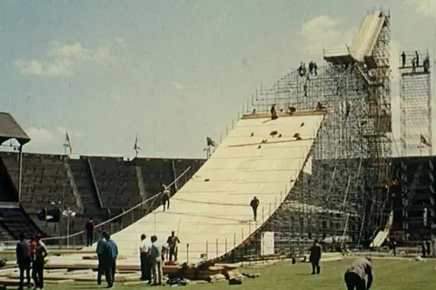British Pathé A ski jump being built from scaffolding in the grounds of Wembley Stadium.
