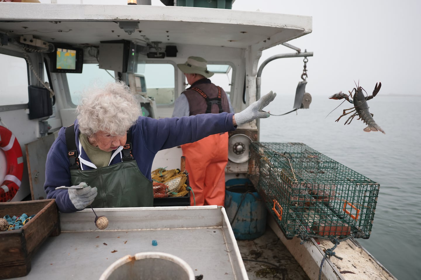 AUGUST 10, ROCKLAND, MAINE  —  Virginia Oliver is 101 and still goes out to haul lobster with her 78-year-old son, Max, three mornings a week. Banding lobster is hard, tedious, repetitive work. It’s no joke. But Virginia makes it look easy. She started when she was 8, before the Great Depression, took time off to raise four children before heading back out. This photo of Virginia “yeeting” a lobster became a meme; she went viral. Someone turned her into Darth Vader and gave the lobster a lightsaber. Mark Hamill commented, “The Force is strong with this lobsterwoman.” I’m sure Luke Skywalker has no idea he made my year. – Jessica Rinaldi