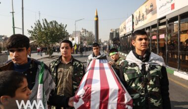 Members of Basij paramilitary forces hold a coffin with the U.S. flag during an anti-Israel rally in Tehran/WANA (West Asia News Agency)