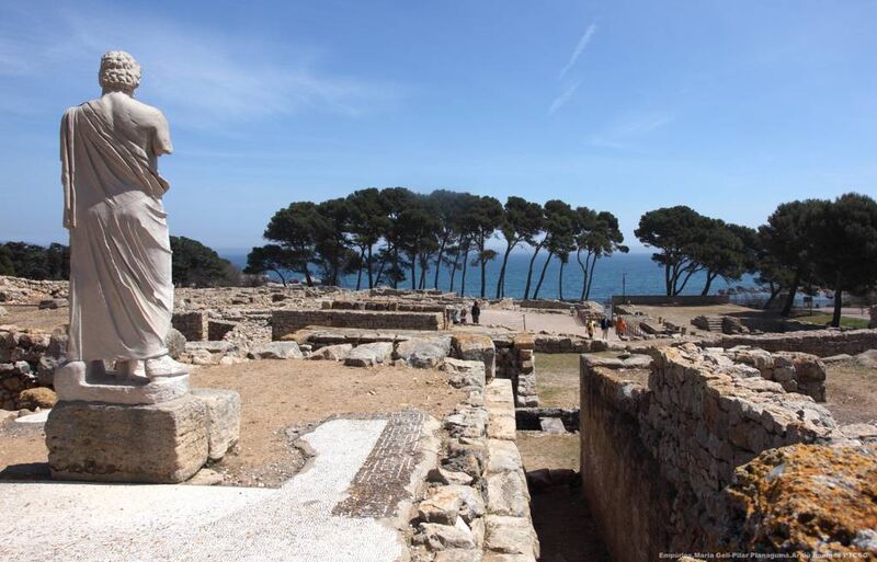 Sculpture of Asclepius in the foreground at the Greco-Roman ruins in Empúries, l'Escala