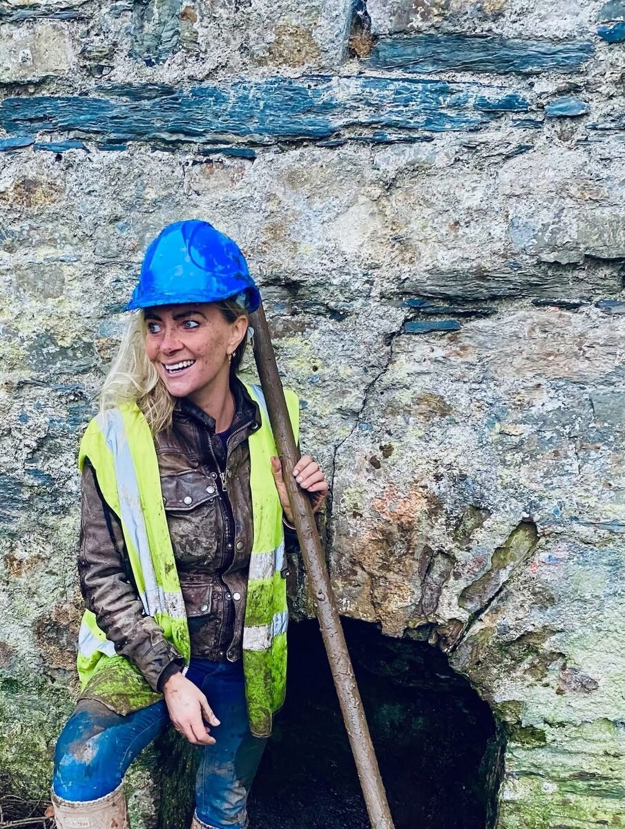  Charlotte working on the restoration of a well in Kinsale. 'We did it! We saved this well and old tower from demolition.'