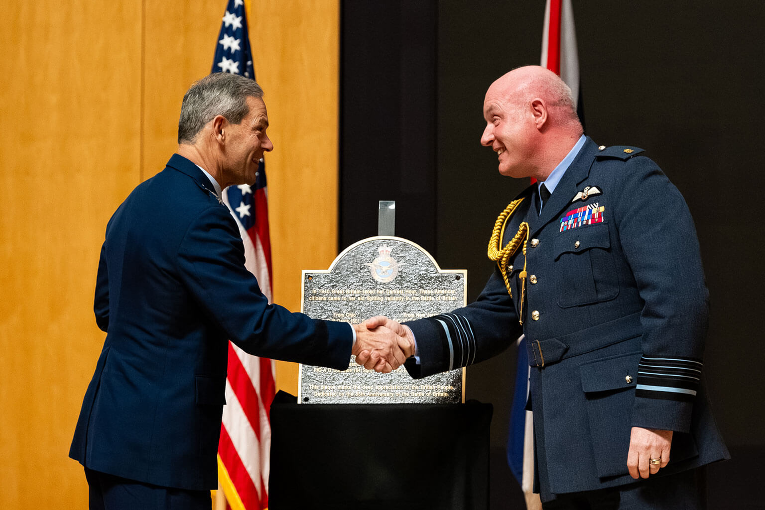 U.S Air Force Chief of Staff Gen. Ken Wilsbach, left, shakes hands with Air Chief Marshal Sir Harvey Smyth, Royal Air Force Chief of the Air Staff, during a Battle of Britain commemoration service in Polaris Hall at the U.S. Air Force Academy, Colo., on Jan. 16, 2026. The ceremony strengthened ties between allied forces and inspired future air-minded warriors. (U.S. Air Force photo by Ray Bahner)