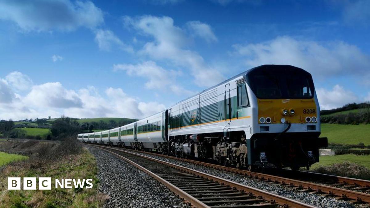 An Enterprise train on a track. It is yellow and green.