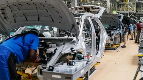 AFP via Getty Images Workers at a Hyundai factory in the US