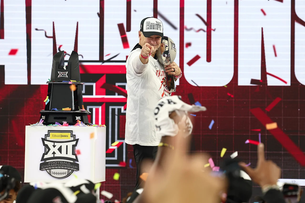 ARLINGTON, TX - DECEMBER 06: Texas Tech Red Raiders head coach Joey McGuire points at his players after receiving the Big 12 championship trophy during the Big 12 Championship Game between the Texas Tech Red Raiders and BYU Cougars on December 6, 2025 at Amon G. Carter Stadium in Fort Worth, TX.  (Photo by Matthew Visinsky/Icon Sportswire via Getty Images)