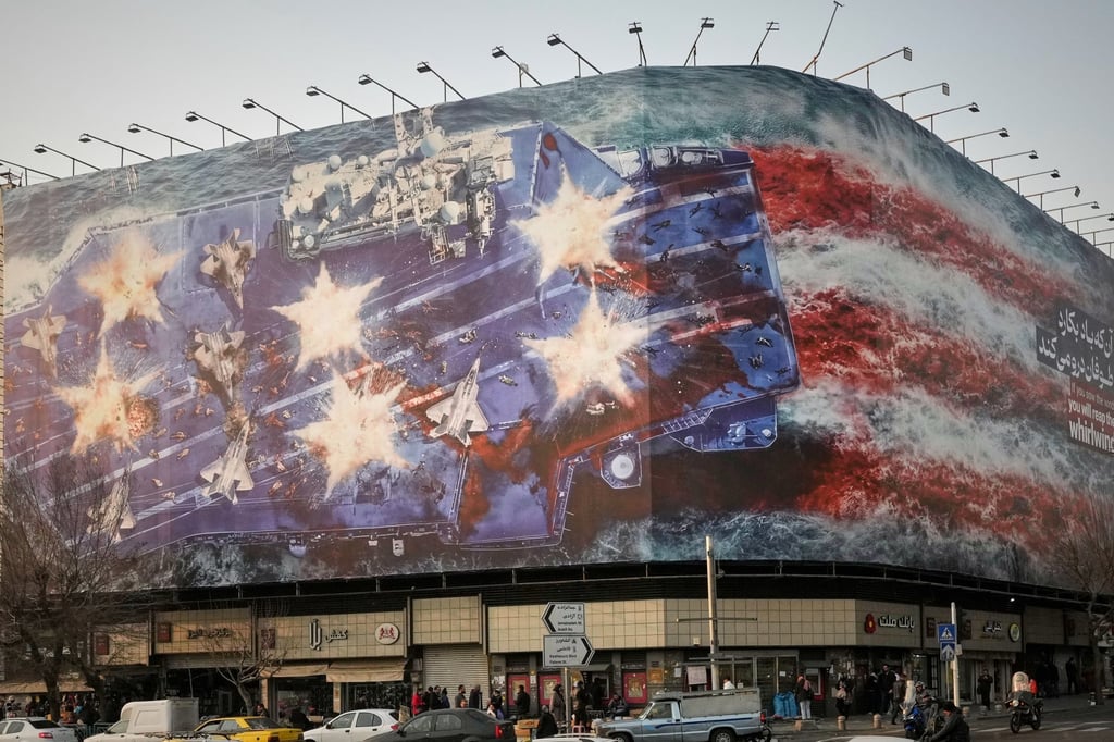 The billboard depicts a damaged US aircraft carrier with disabled fighter jets on its deck. Photo: AP