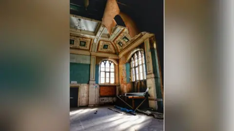 Mark McLaughlin A derelict ornate room with large windows 