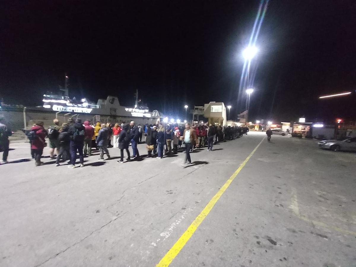 The long queue stretched far back down the terminal quay.