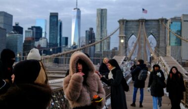 People brave the cold on the Brooklyn Bridge in New York City ahead of Winter Storm Fern