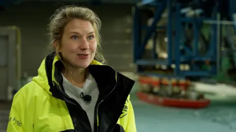 James Brooks Icebreaker engineer Riikka Matala wearing a fluorescent jacket