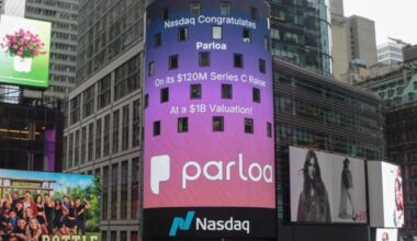 A large Nasdaq digital billboard in Times Square congratulates Parloa on its $120 million Series C funding round and $1 billion valuation, surrounded by other illuminated advertisements and high-rise buildings.