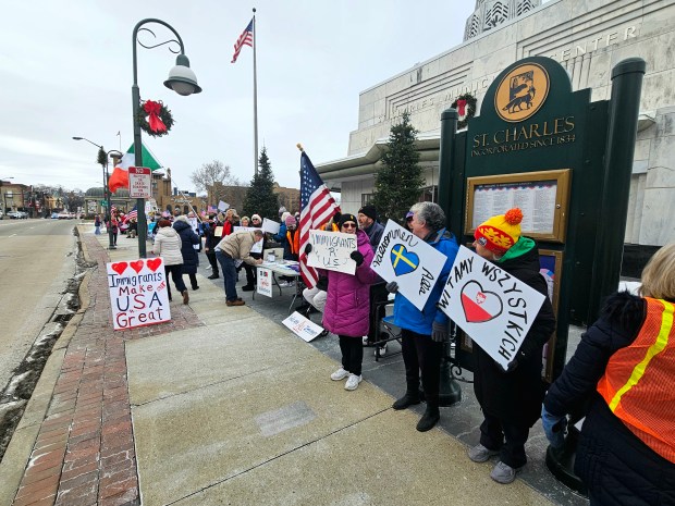 Participants line Main Street in downtown St. Charles on Saturday, Jan. 3, 2026, during a rally to honor immigrants and their contributions to the Fox Valley. (David Sharos/For The Beacon-News)