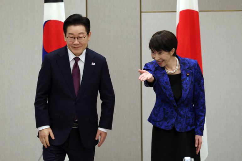 South Korea's President Lee Jae Myung is escorted by Japan's Prime Minister Sanae Takaichi at the start of their meeting in Nara, Nara Prefecture on January 13, 2026. (Photo by Issei Kato / POOL / AFP)