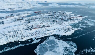 Houses covered by snow are seen on the coast of a sea inlet of Nuuk, Greenland.