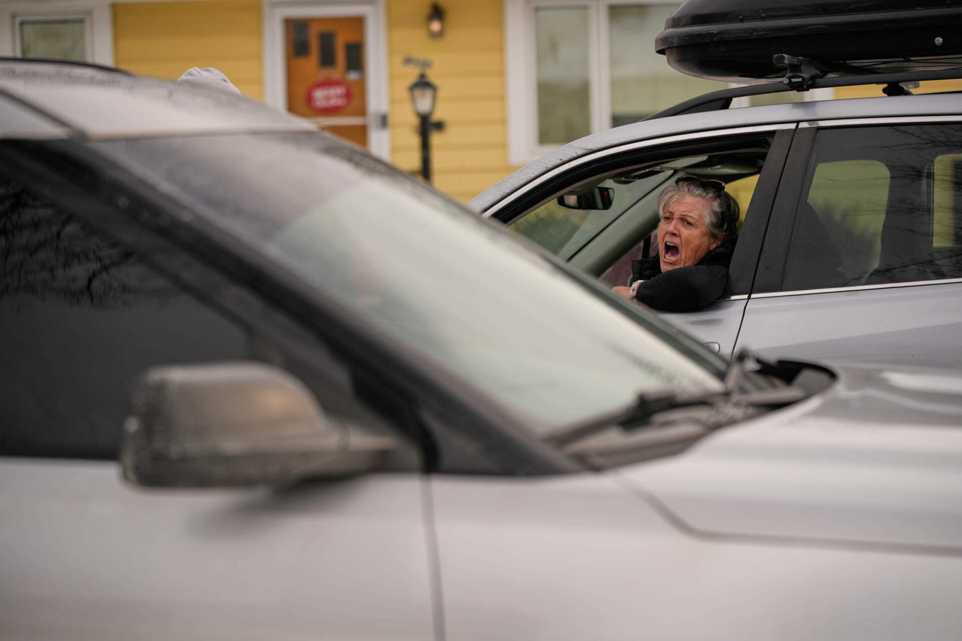 A woman yells at federal immigration officers as they make an arrest Sunday, Jan. 11, 2026, in Minneapolis. (John Locher/AP)