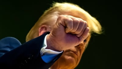 Trump gestures as he climbs a staircase after a signing ceremony of his Board of Peace initiative at the World Economic Forum in Davos. (AP)