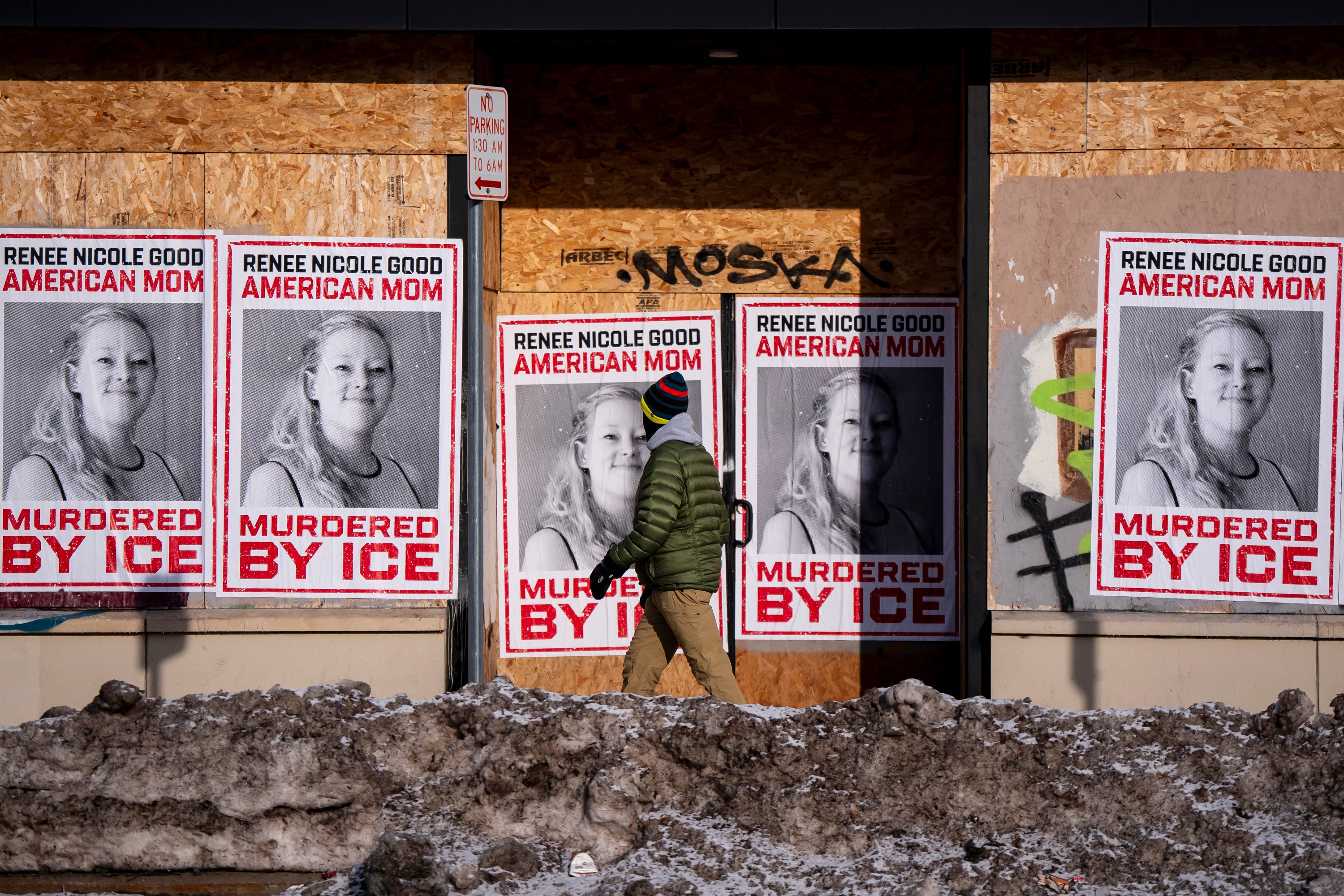 A person walks past signage for Renee Good, who was fatally shot by an ICE officer earlier in the week, in Minneapolis, Minn., Sunday, Jan. 11, 2026. (Christopher Katsarov/The Canadian Press via AP)