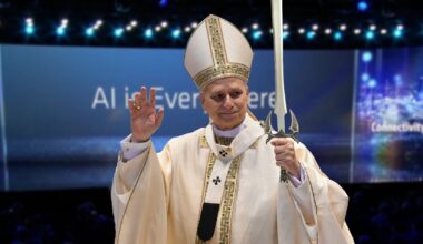 Pope Leo holds a photoshopped sword atop a slightly blurry image of an AMD AI presentation.