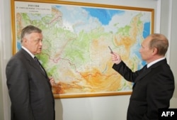 Vladimir Yakunin (left), who headed Russian Railways for a decade until being pushed out in 2015, is a former KGB officer, diplomat, St. Petersburg resident, and close neighbor of President Vladimir Putin.