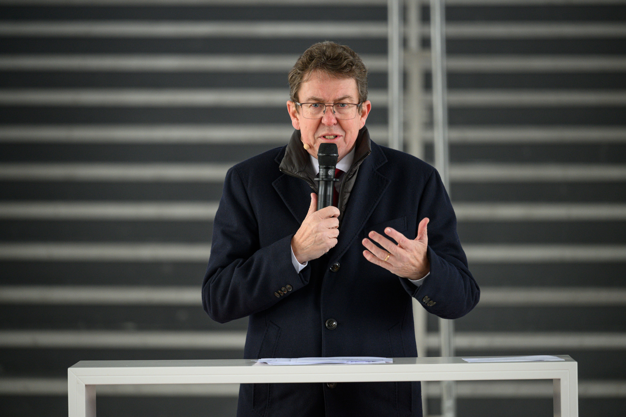Albert Rösti parle lors d’un événement SBB à Bâle en novembre 2025, devant des escaliers.
