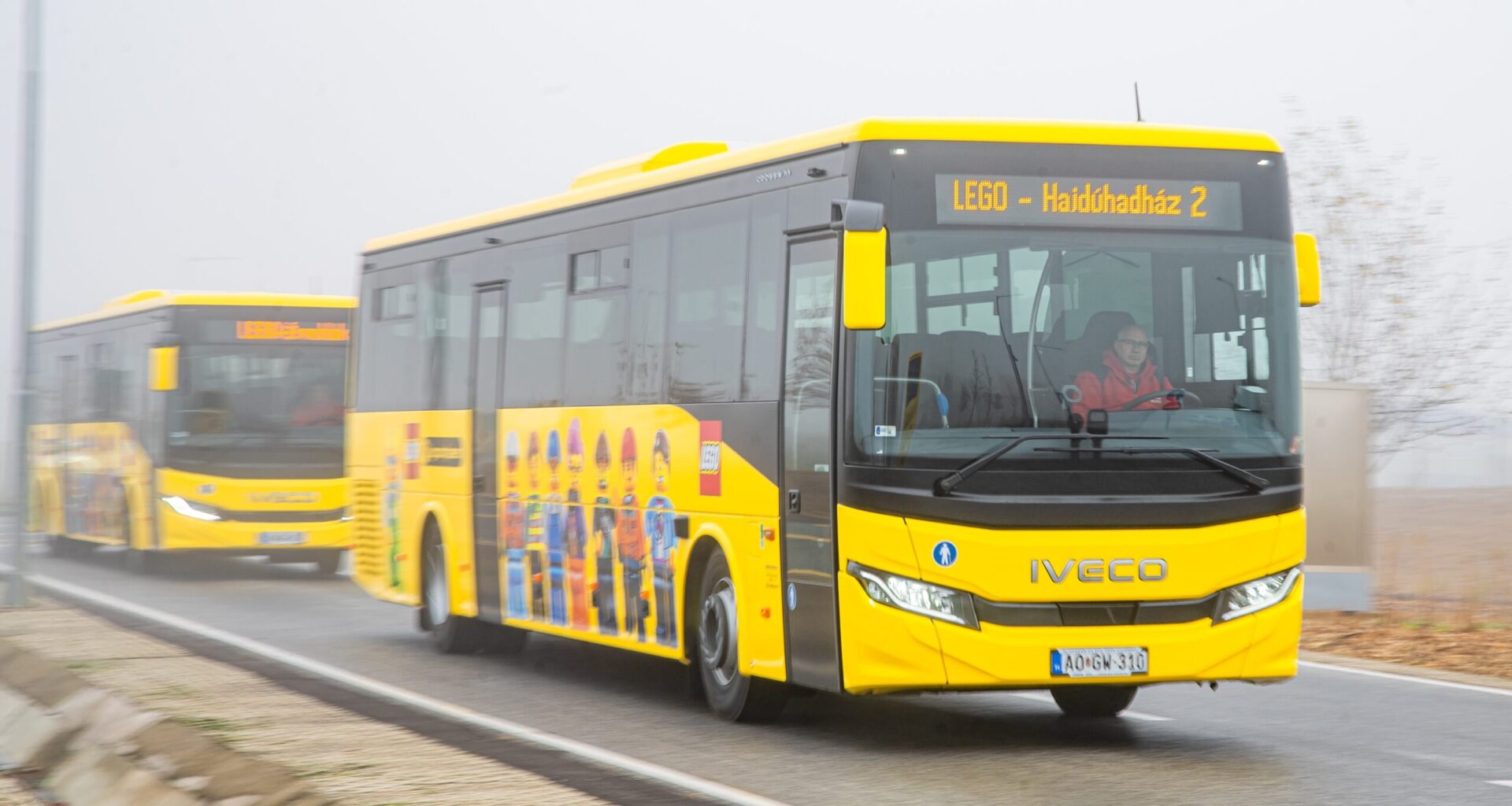 A yellow bus with LEGO people on the side