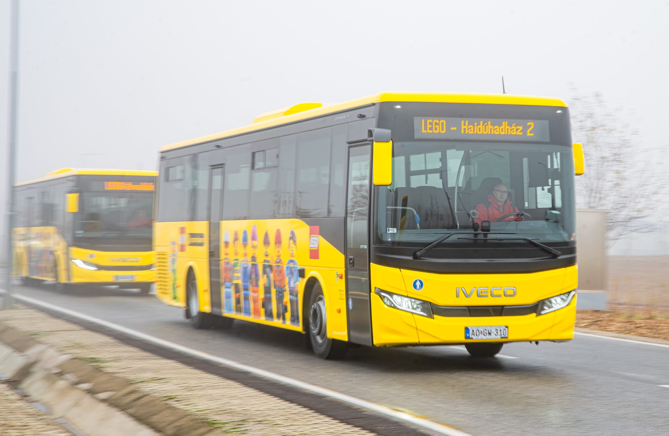 A yellow bus with LEGO people on the side
