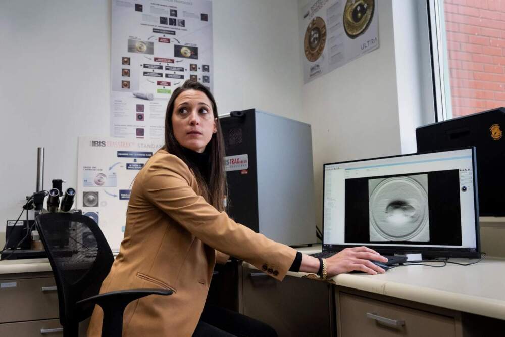 Rachel Beninati, a forensic science examiner, shows how the The NIBIN analyzation system at the Connecticut Forensics Lab works in Meriden, Connecticut on December 29, 2025. (Ayannah Brown/Connecticut Public)