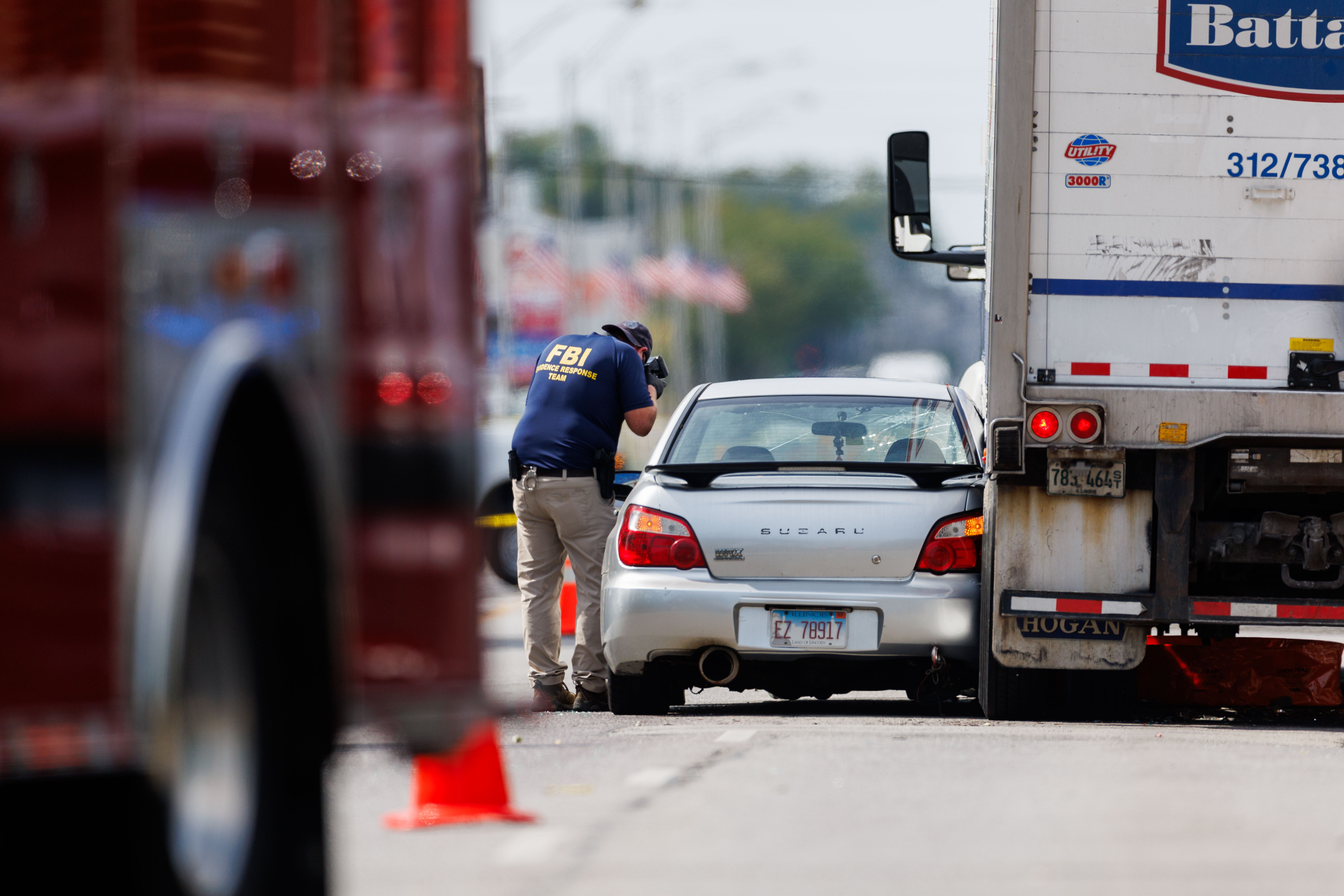 FBI agents and other law enforcement officers investigate the scene...