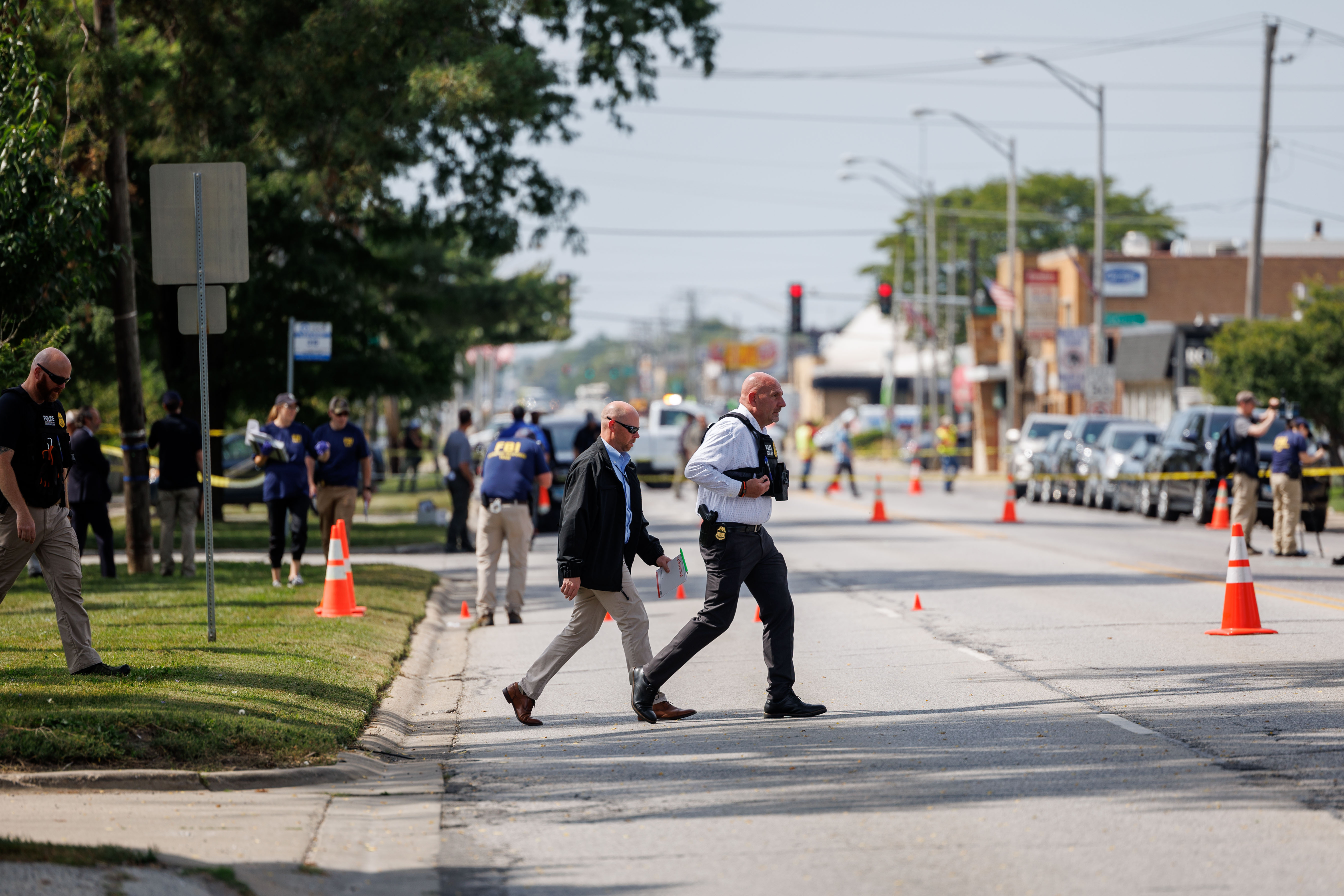 The FBI and other law enforcement officers investigate the scene...