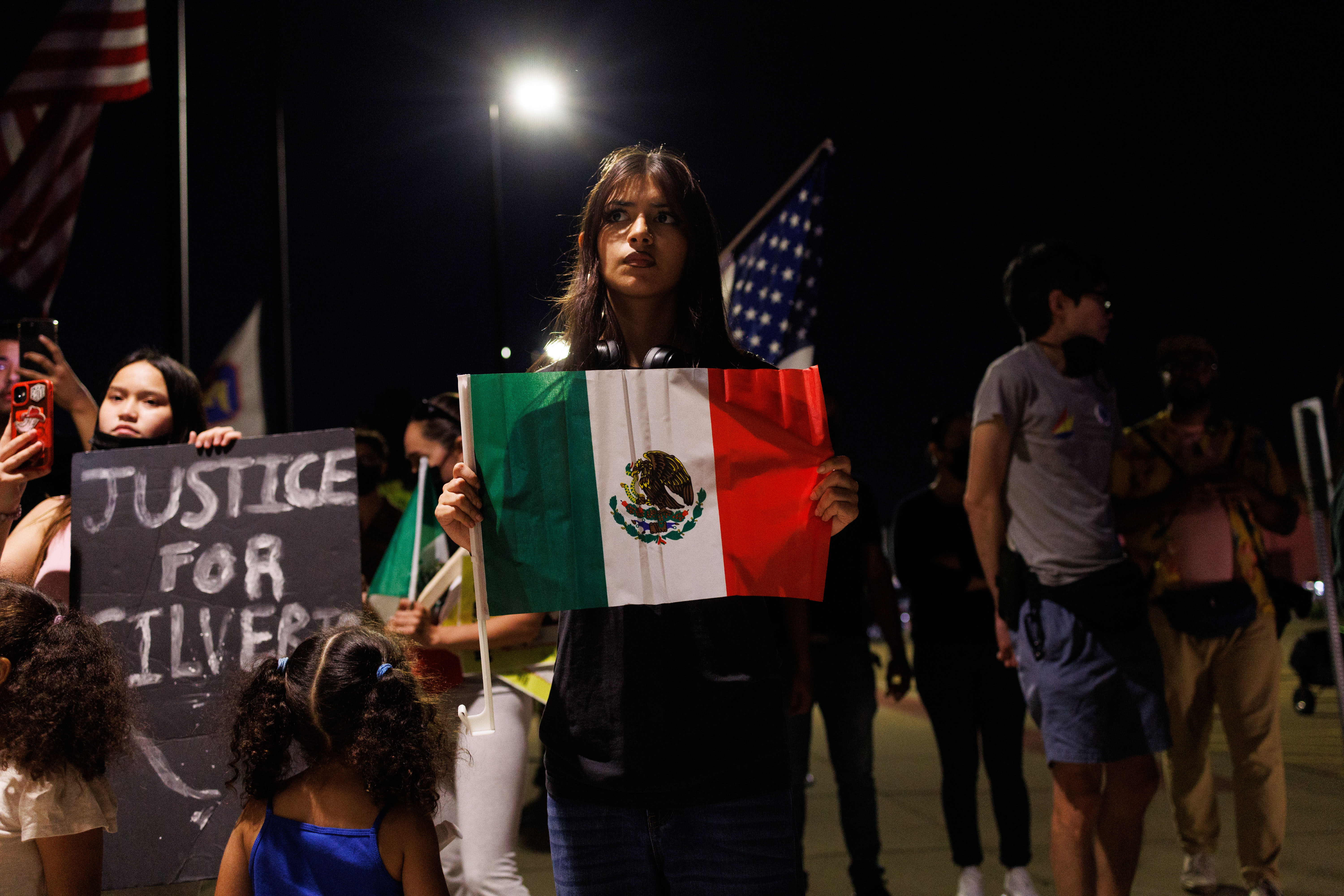 People gather outside the village of Franklin Park police station...