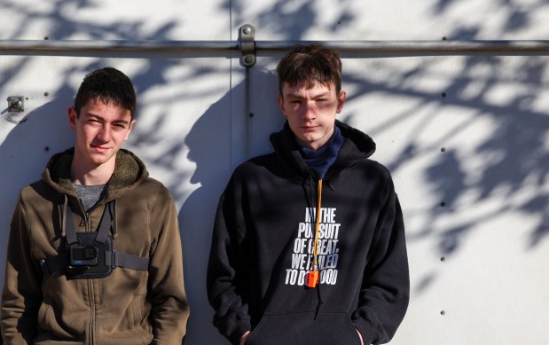 Brothers Sam and Ben Luhmann stand outside of the trailer of four landscapers were detained on Nov. 7, 2025, in St. Charles. (Stacey Wescott/Chicago Tribune)