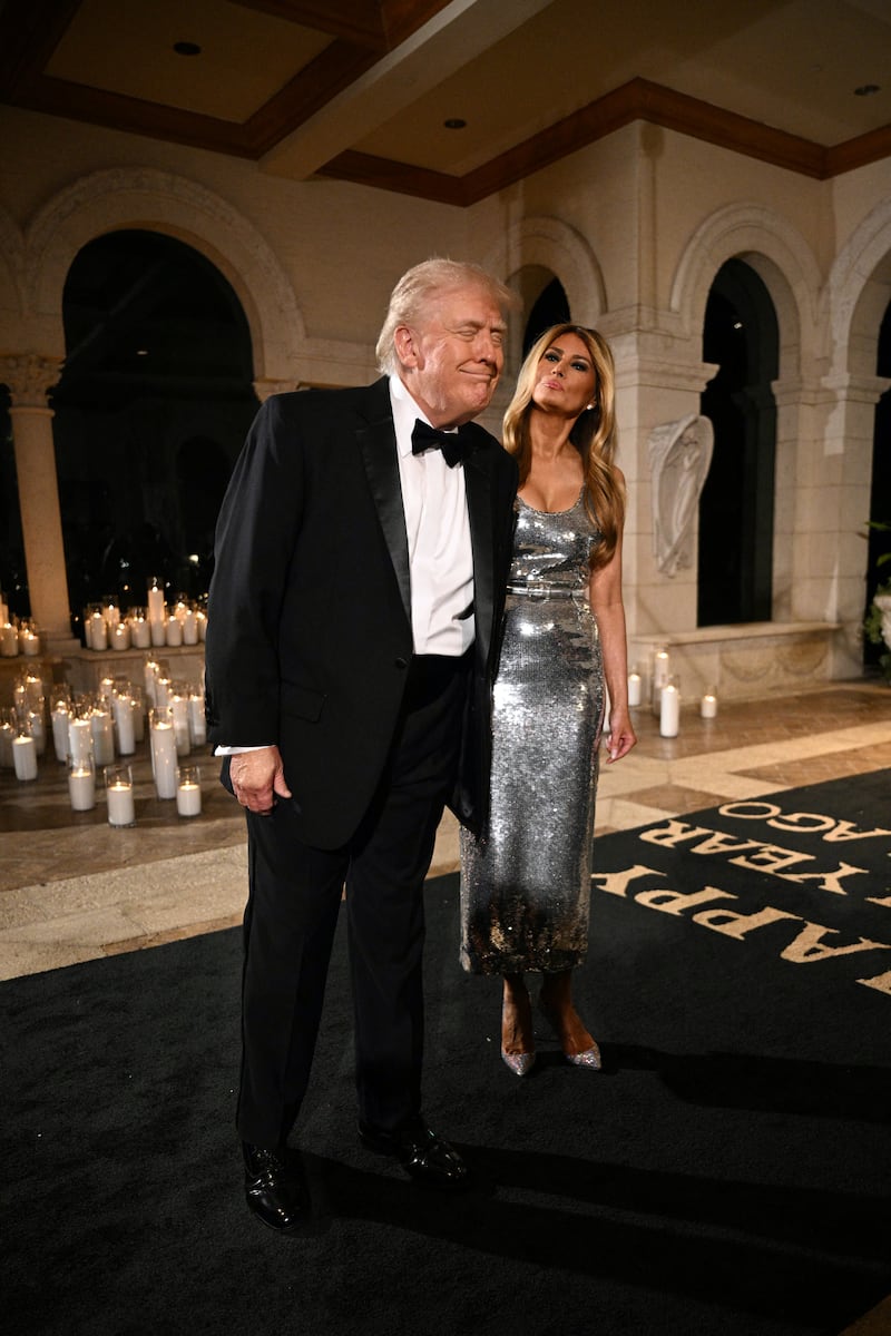 US President Donald Trump and First Lady Melania Trump attend the New Year's Eve Party at his Mar-a-Lago residence in Palm Beach, Florida on December 31, 2025. (Photo by Jim WATSON / AFP via Getty Images)