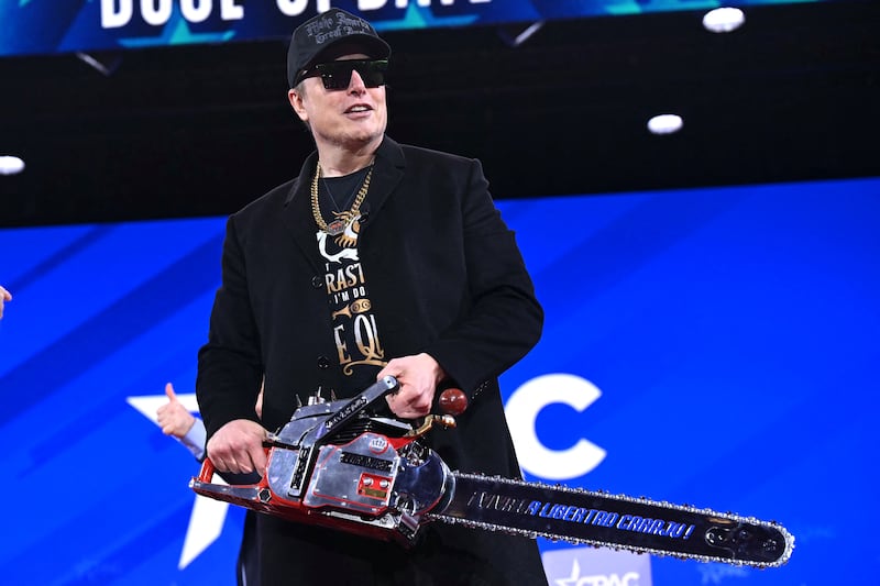 Elon Musk holds a chainsaw reading "Long live freedom, damn it" during the annual Conservative Political Action Conference (CPAC) at the Gaylord National Resort & Convention Center at National Harbor in Oxon Hill, Maryland, on February 20, 2025. The chainsaw was a present to Elon Musk from Argentina's President Javier Milei. (Photo by SAUL LOEB / AFP) (Photo by SAUL LOEB/AFP via Getty Images)
