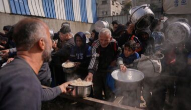 Palestinians receive donated food at a community kitchen in Nuseirat, in central Gaza Strip, Saturday, Jan. 24, 2026. (AP Photo/Abdel Kareem Hana)
