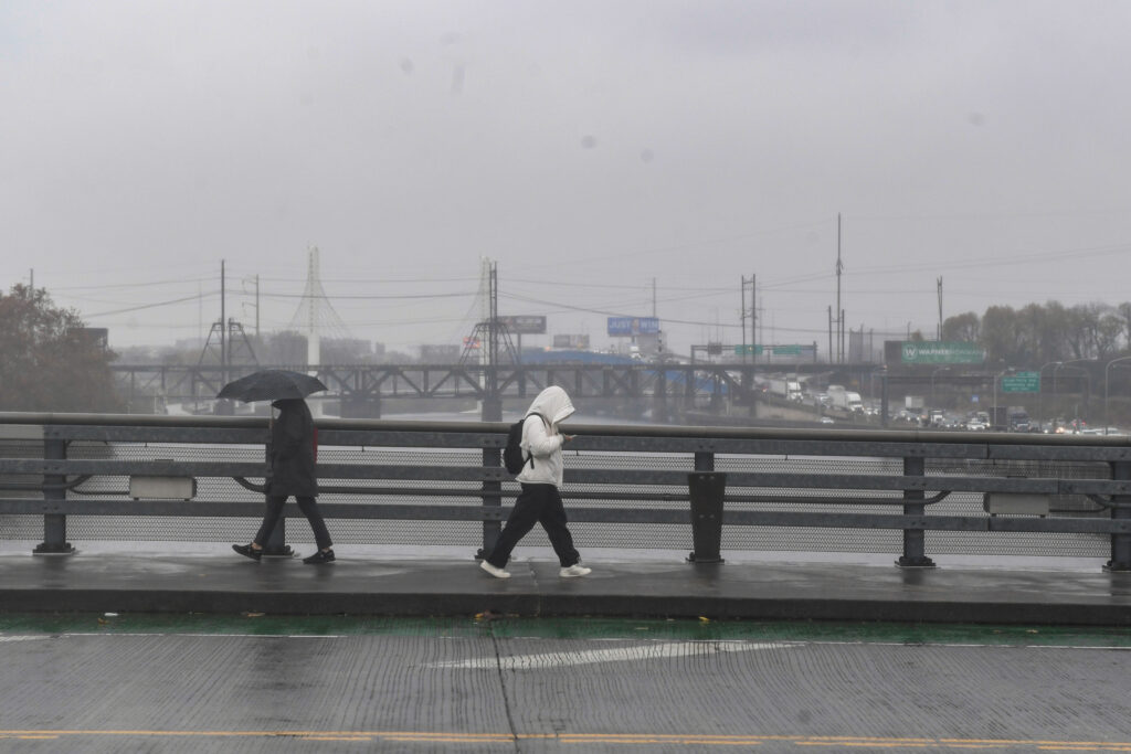 People walk through rain showers and cold temperatures in Philadelphia on Nov. 19. Credit: Matthew Hatcher/Getty Images)