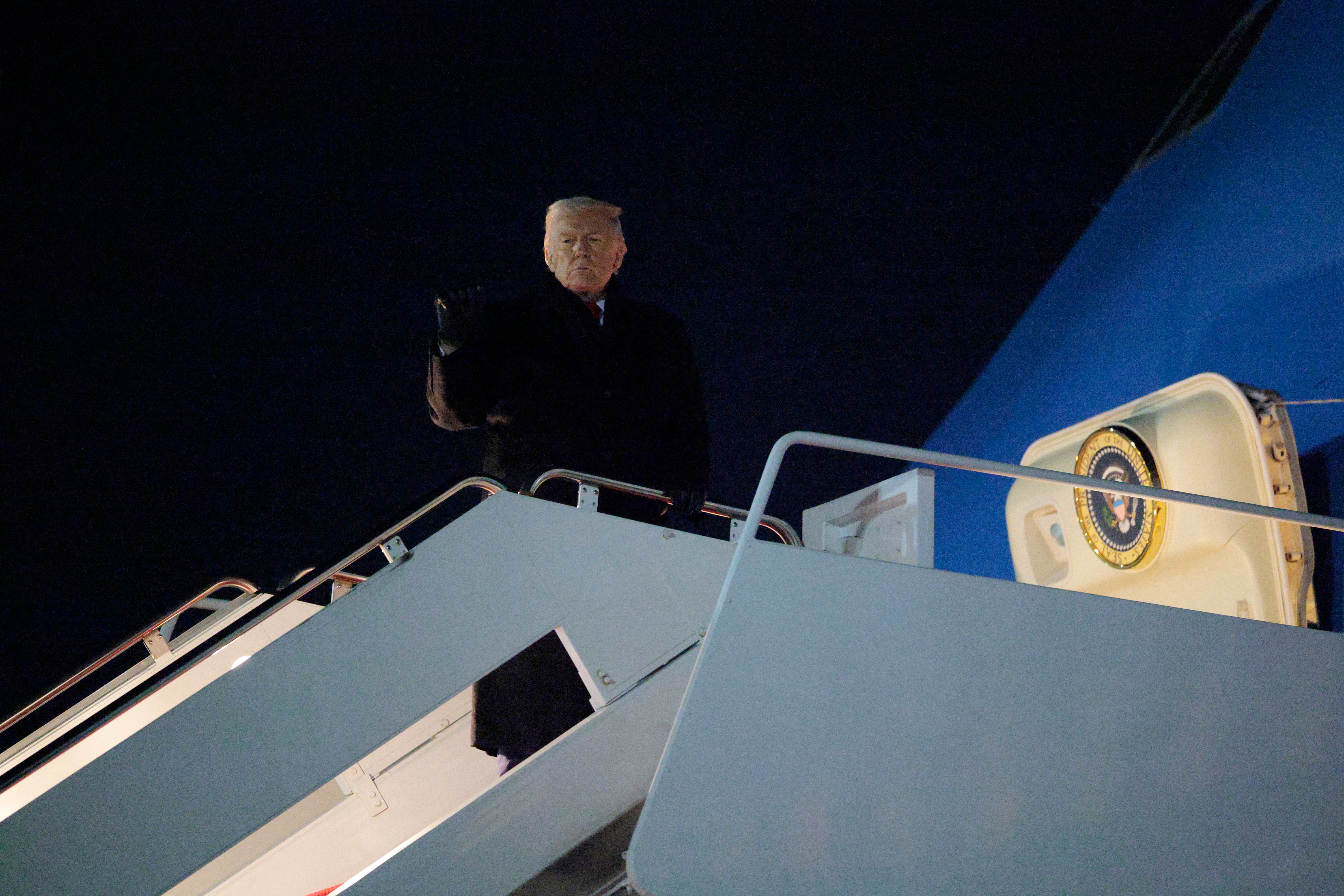 U.S. president Donald Trump gestures as he boards Air Force One as he leaves Washington for Switzerland on January 20, 2026 in Joint Base Andrews, Maryland