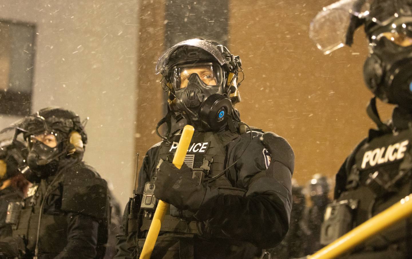 Protesters clash with law enforcement while holding a 'noise demonstration' outside of a hotel believed to be housing federal immigration agents near Minneapolis, United States, on January 26, 2025.