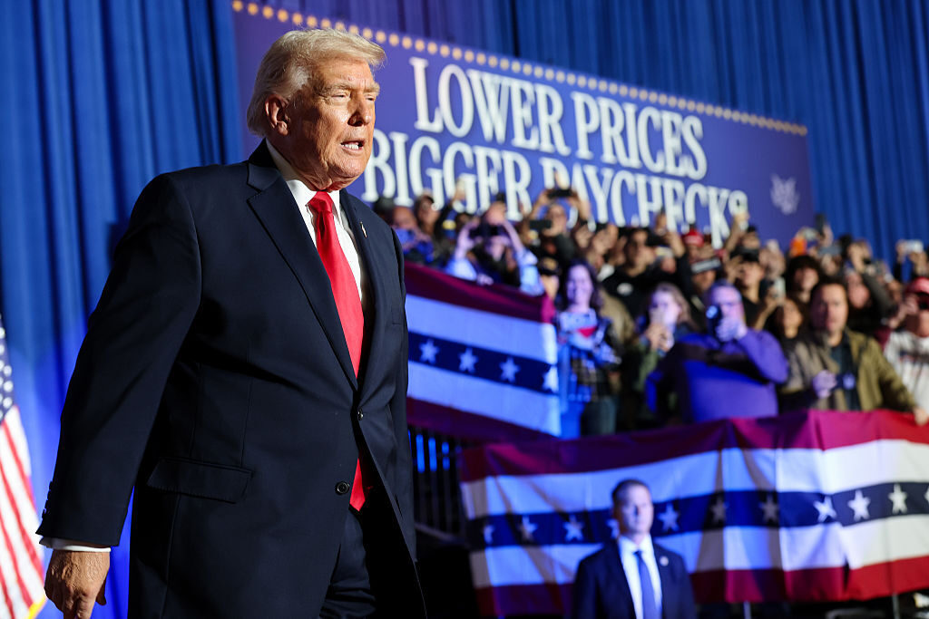President Donald Trump takes the stage to speak during a rally in Clive, Iowa, on Tuesday.